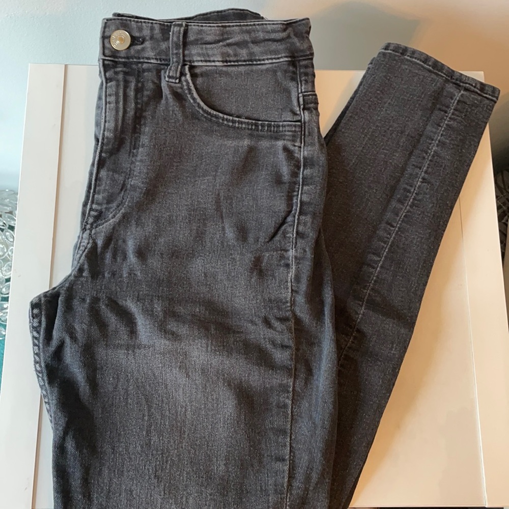 High waisted dark grey skinny jeans.